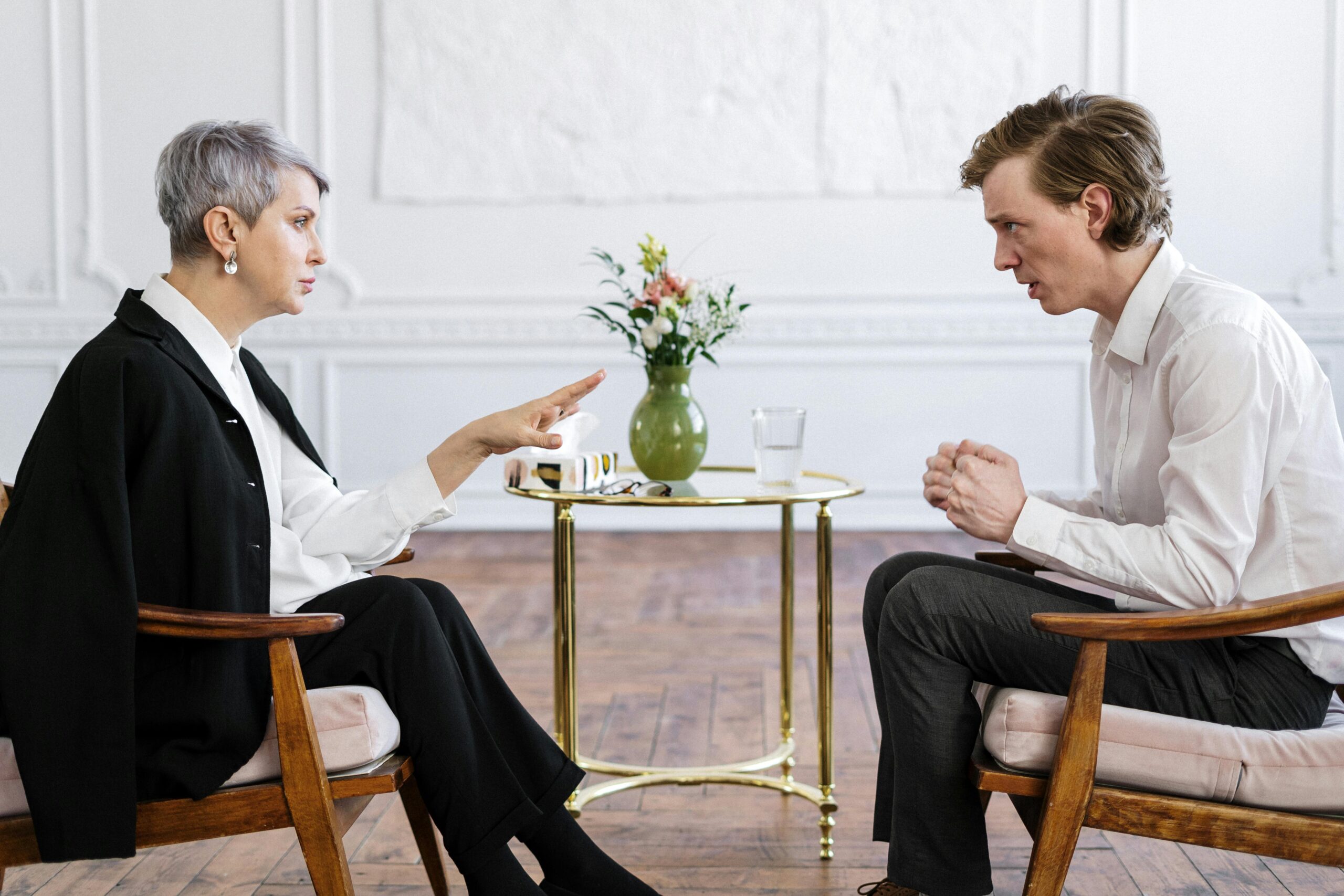 Man speaks to woman in therapy.