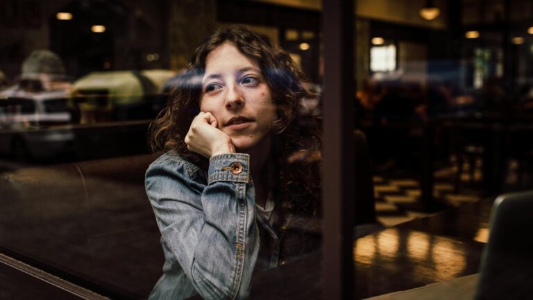 Woman looking out of a window.