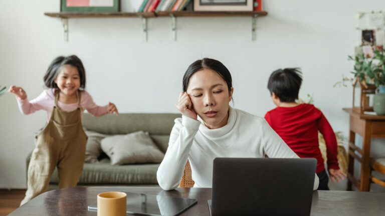 Stressed mom works at a computer.