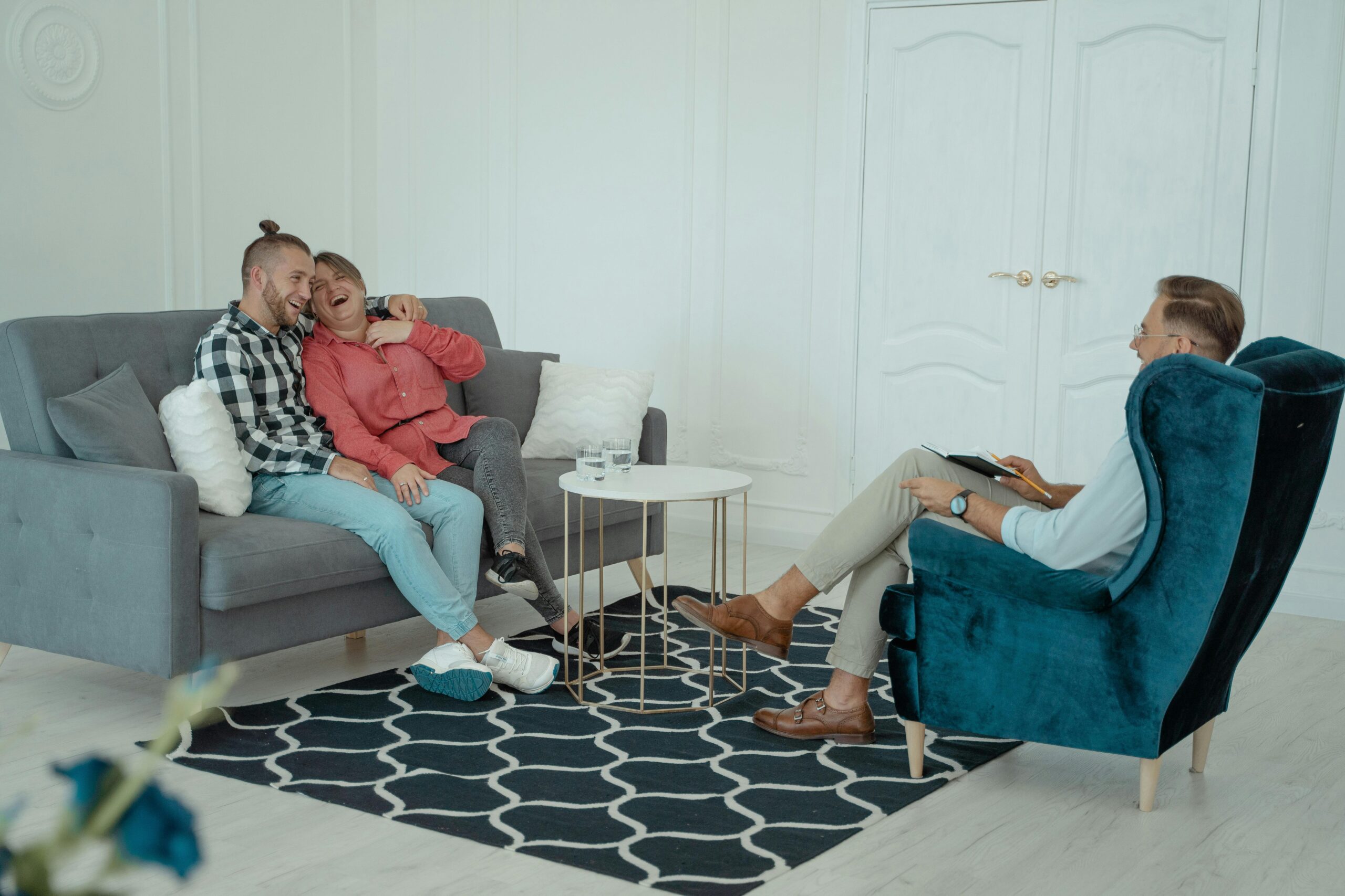 Couple laughing in therapy session.