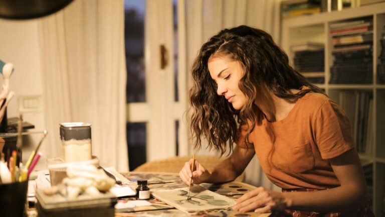 Woman works on art project.
