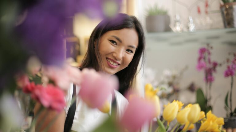 Florist peaks through flowers.