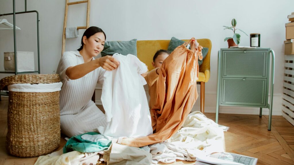 Woman and child fold clothing.