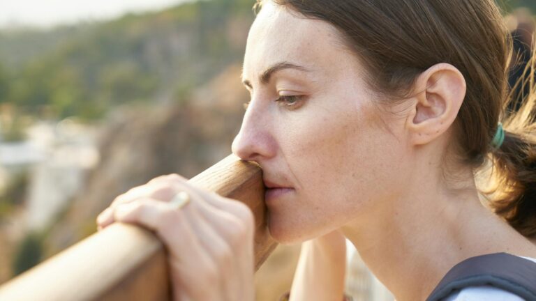 Woman stares off in the distance.