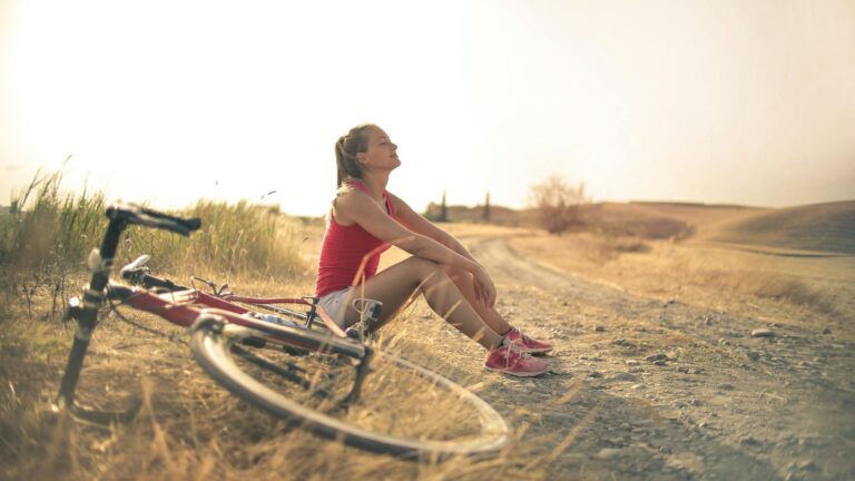 Woman catches breath after bike ride