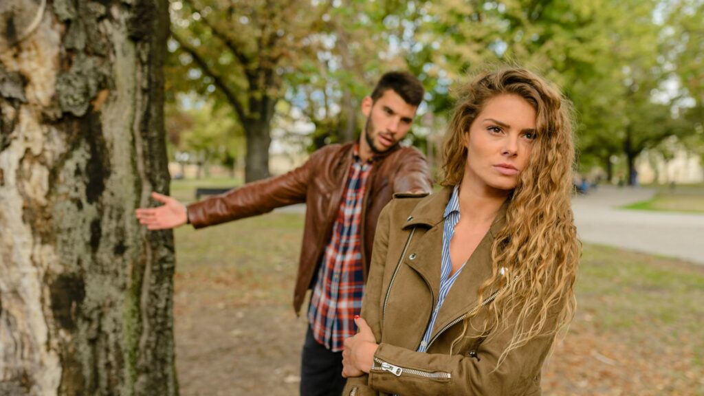 Woman walks away from argument with a man.